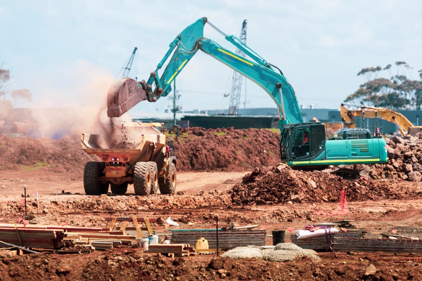 Excavator loading a dump truck on a construction site