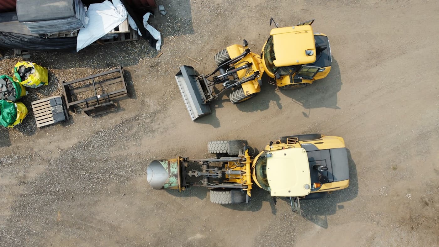 Wheel loaders and attachments in an equipment yard from above