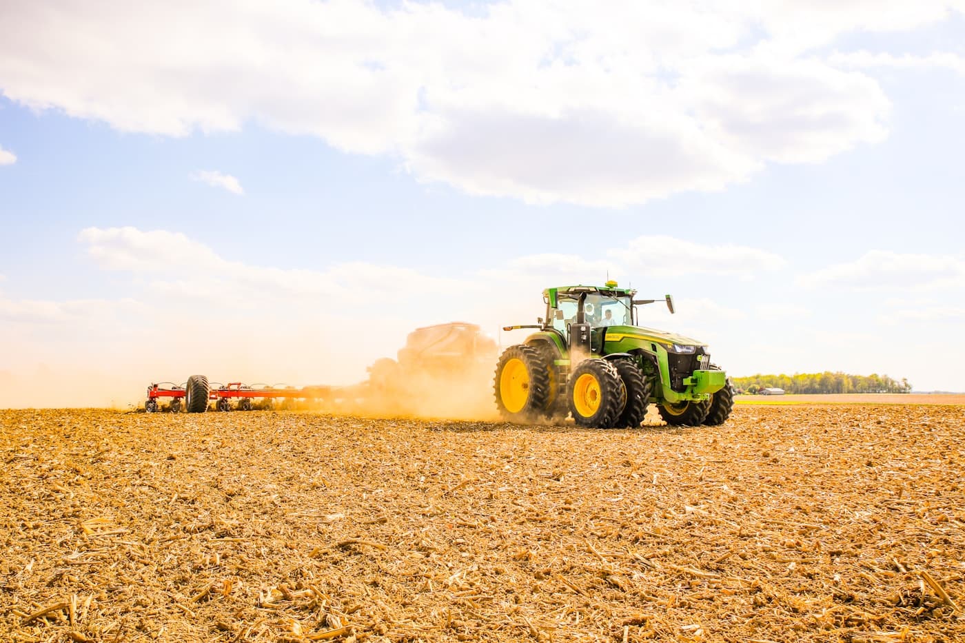 Tractor towing an air seeder across a paddock